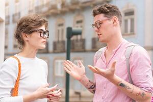Young beautiful hipster couple in sunglasses in love walking on old city street photo