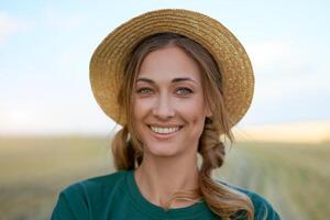 Woman farmer straw hat standing farmland smiling Female agronomist specialist farming agribusiness Happy positive caucasian worker agricultural field photo