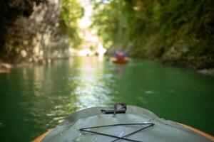 Kayaking on the river. group of people in a boat sailing along the river. Rowers with oars in a canoe. Rafting on a kayak. Leisure. photo