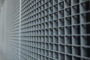 Metal lattice with small cells grid stock background with shallow dof and selective focus photo