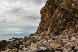 yellow rock near the sea photo