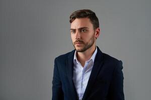 Close up portrait young man businessman. Caucasian guy business suit studio gray background. photo