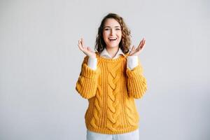 Young Woman Model Expresses Surprise and Excitement - Wow Expression, Positive Surprise, Amazement - Screaming Advertisement for Discounts, Promotions, Sales Offers. White Background. Shopping Concept photo