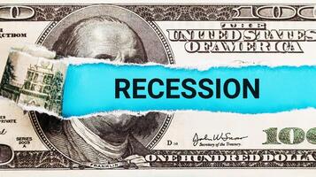 Recession. The word Recession in the background of the US dollar. Financial Downturn, Unemployment, and Economic Recession Concept photo