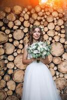 Full length side view of one beautiful sensual young blonde bride in long white wedding dress photo