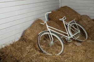 Old bicycle with hay bale with retro effect photo