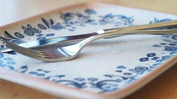 fork, knife and a circle shape plate on table video