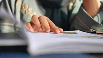 woman hand reading a food menu at cafe. video