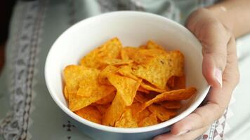 woman hand pick potato chips from a bowl video