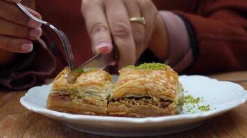 woman cutting turkish dessert baklava with knife video