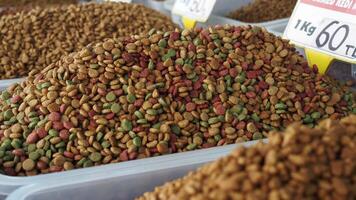 stack of dried cat food display for sale at local market video