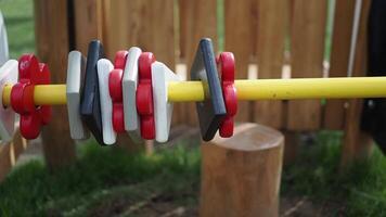 a wooden toy with red white and black squares and yellow sticks video