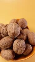 A scoop of walnuts, a superfood, rests on a stack of nuts seeds video