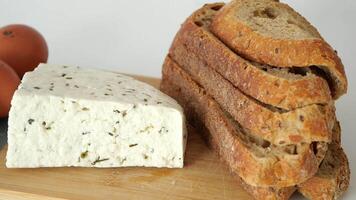 herb cheese and slice of brown bread on table video