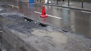 Big pot hole filled with water at street video