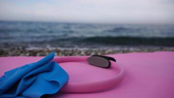 Magic pilates ring and rubber band on yoga mat near sea Female fitness yoga concept. Healthy lifestyle harmony and meditation. Close up. video