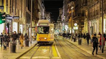 MILAN ITALY 19 FEBRAURY 2021 Milan street at night with trams and people walking around video