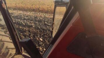 Detail of a tractor plowing in the field on farm video