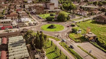 Aerial View of Traffic Roundabout at Sunset, Surrounded by Greenery video