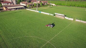 Aerial View of Lawn Tractor Mowing Soccer Field for Sports Facility Maintenance video