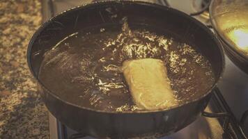 Hot Asian spring rolls are finished frying in steel wok video