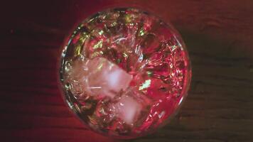 Slow motion of falling ice cube into whiskey glass video