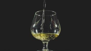 Pouring alcohol drink whiskey, cognac into glass video
