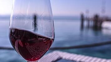 Wine glass on seafront table video