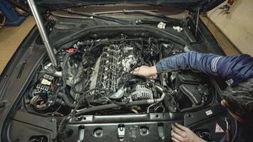 Mechanic repairs car engine video