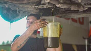 Mechanic extracted car oil video