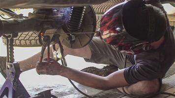 Mechanic repairs car welding 4 video