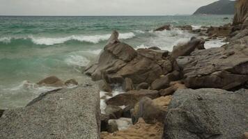 dettaglio di un' roccioso spiaggia tipico di meridionale sardegna con uno piede In arrivo su per il lato video