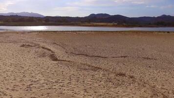 Beach and mountains of south Sardegna in Italy taken from above video