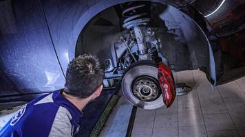 Milan Italy 29 october 2022 Mechanic hands detail during a maintenance of car suspension video