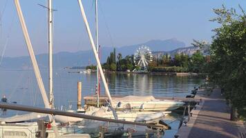 BARDOLINO ITALY 16 SEPTEMBER 2020 Panorama of Garda Lake in Bardolino with Ferris wheel during summer video