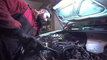 MILAN ITALY 20 JANUARY 2020 Mechanic repairs car engine in a workshop video