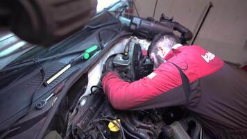 MILAN ITALY 20 JANUARY 2020 Mechanic repairs car engine in a workshop video