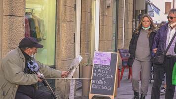 ROVIGO ITALY 30 OCTOBER 2021 Street musician people walk and city life in Italy video