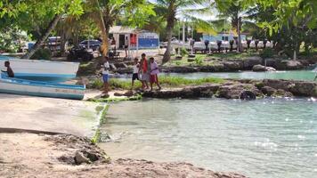 BAYAHIBE DOMINICAN REPUBLIC 23 DECEMBER 2019 Poor Dominican children play in Bayahibe beach in total happiness and joy video