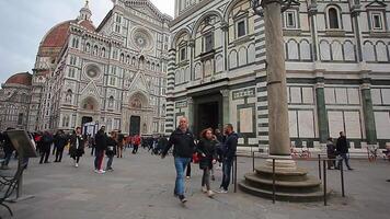 Detail of the Piazza del Duomo in Florence with tourists visiting it on a cloudy day with the light that enhances the colors video