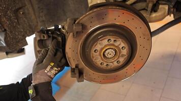 Milan Italy 11 april 2023 Skilled mechanic expertly replaces brake pads on a car with precision and care video