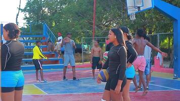 BAYAHIBE DOMINICAN REPUBLIC 22 JANUARY 2020 Black boys play volleyball and basketball filmed behind the net in the Dominican Republic video