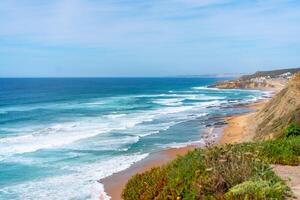 Aerial view of tropical sandy beach and ocean with turquoise water with waves. Sunny day on Atlantic ocean beach photo