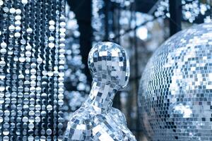 Male mannequin covered with slices of a mirror on a black background mr disco photo