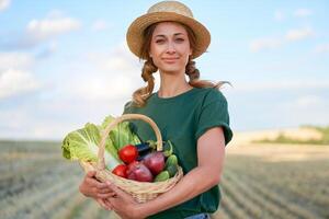 Woman farmer straw hat apron standing farmland smiling Female agronomist specialist farming agribusiness Happy positive caucasian worker agricultural field photo