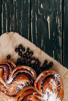 Rustic with black current berry pie on black wooden background. photo