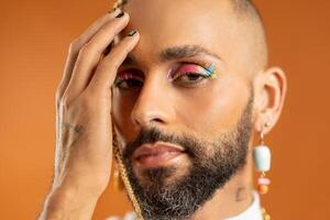 Black latin gay man isolated on pink background photo