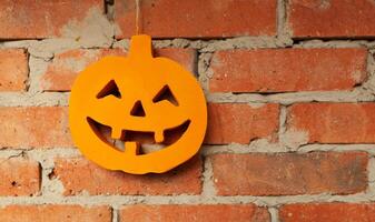 Halloween pumpkin close up on the brick wall background photo