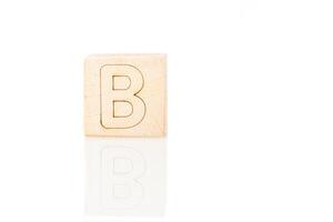 Wooden cubes with letters B on a white background photo