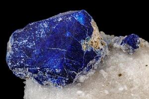 Macro of mineral stone Lazurite on a black background photo